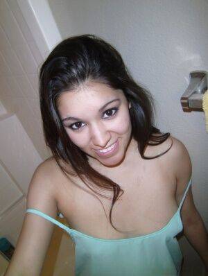 Petite amateur brunette cutie Selena takes a selfie of her hot tits and ass on nudepicso.com
