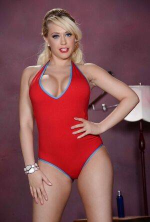 Blonde pornstar Kagney Linn Karter is posing in a red bikini outfit on nudepicso.com