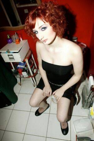 Pale redhead Violet Monroe gets naked in flat shoes while in a bathroom on nudepicso.com