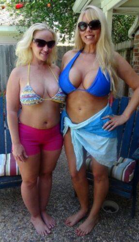 Blonde women Karen Fisher and Dee Siren loose their big tits from bikini tops on nudepicso.com