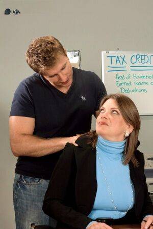 Chubby cougar Randi Layne is seduced by a younger boy during tax season on nudepicso.com