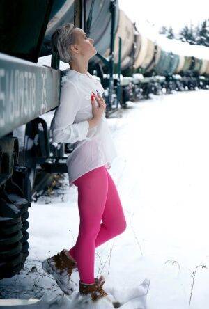 Short haired female displays her snatch by a train in crotchless hose on nudepicso.com