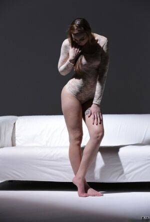 Bare legged solo model Lulu Love shows off her pretty feet in a onesie on nudepicso.com