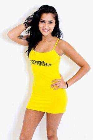 Latina teen Giselle Mari removes a yellow spaghetti strap dress to pose nude on nudepicso.com