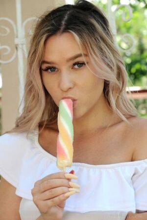 Dirty blonde teen Angelina Ash eats a frozen treat while getting totally naked on nudepicso.com