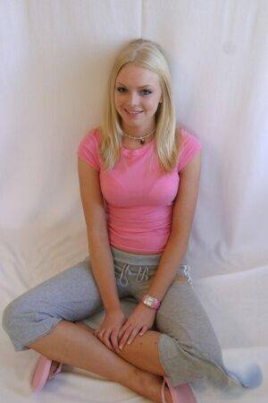 Cute teen girl Skye Model hangs out in a pink shirt and her yoga pants on nudepicso.com