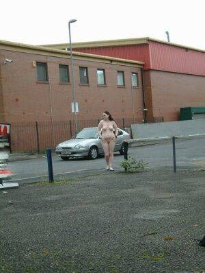 Plump girl goes for a naked walk in parking lot in industrial area on nudepicso.com