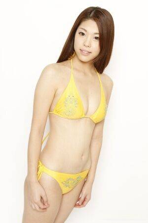 Young Japanese redhead models a yellow bikini in a safe for shoot - Japan on nudepicso.com