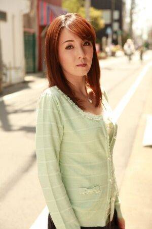 Japanese redhead Chika Sasaki models in a sweater and skirt in the road - Japan on nudepicso.com