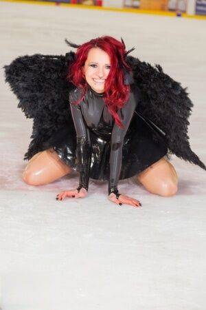 Redhead amateur Lara Larsen models non nude in latex attire with wings on nudepicso.com