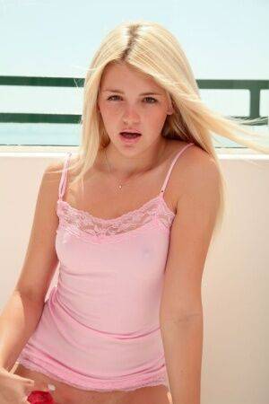 Sweet blonde girl Holly Van Hough gets naked and pleasures herself on balcony on nudepicso.com