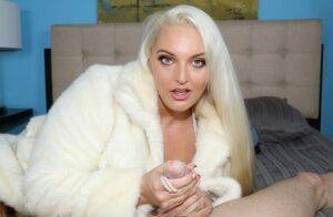 Platinum blonde chick Macy Cartel tugs on a dick while draped in a fur coat on nudepicso.com