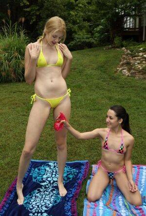 Short and tall lesbians remove bikinis before scissoring and fisting in yard on nudepicso.com