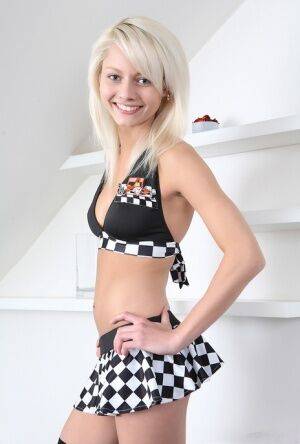 Young blonde Pinky June showcases her tight slit in long checker-board socks on nudepicso.com