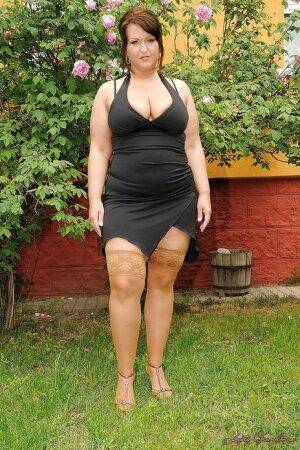 Seductive mature plumper in stockings taking off her dress outdoor on nudepicso.com