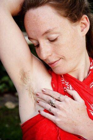 Barefoot redhead Ana Molly displaying hairy underarms and vagina outside on nudepicso.com
