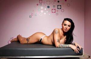 Tattooed female Christy Mack exposes her big tits and sexy as in heels on nudepicso.com