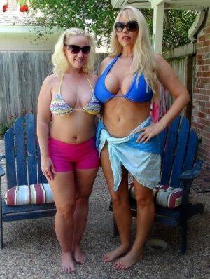 Blonde chicks Karen Fisher and Dee Siren loose their big tits from bikini tops on nudepicso.com