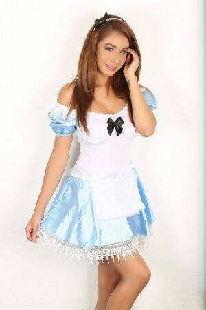 Naughty girl flashes no panty upskirt wearing Alice In Wonderland attire on nudepicso.com