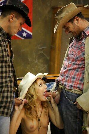 Slippy blonde cowgirl has some double penetration fun with two hung lads on nudepicso.com