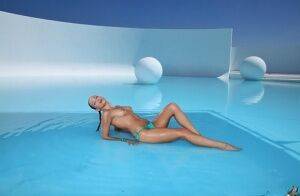 Lovely girl in glasses and bikini Celeste Star enjoys swimming in pool on nudepicso.com