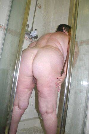 Obese granny Grandma Libby fondles her naked body while taking a shower on nudepicso.com