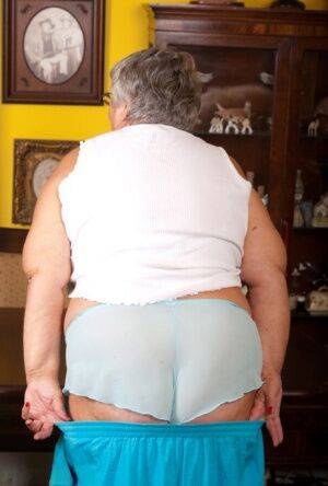 Obese UK lady Grandma Libby completely disrobes on a dining chair - Britain on nudepicso.com