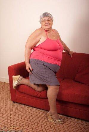 Obese nan Grandma Libby gets totally naked on a red chesterfield on nudepicso.com