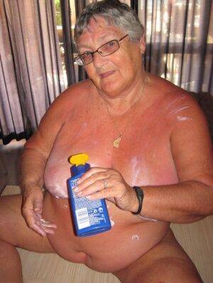 Obese old woman Grandma Libby covers her naked body in lotion on nudepicso.com