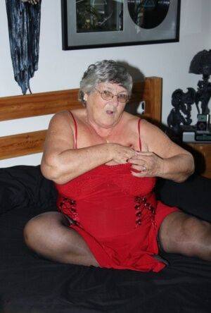 Overweight nan Grandma Libby finger fucks on a bed in lingerie and nylons on nudepicso.com