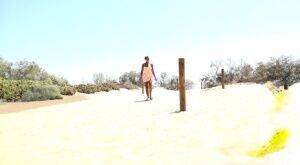 Solo girl Chloe Lamour takes a big piss while crossing a patch of sand on nudepicso.com