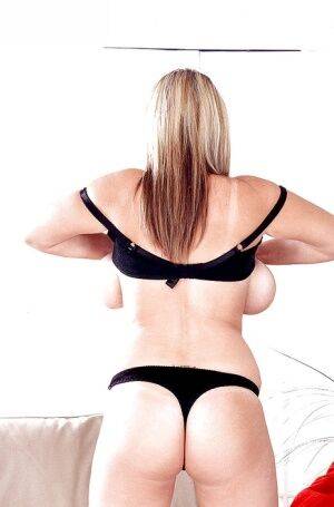 Blonde European MILF pornstar Kelly Kay unleashing huge boobs from lingerie on nudepicso.com
