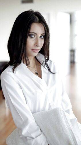 Brunette babe Jade Jantzen posing fully clothed in white blouse and skirt on nudepicso.com