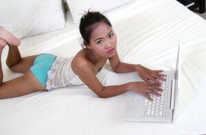 Petite Asian girl launches her nude modeling career atop white bed sheets on nudepicso.com