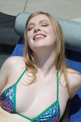 Pale blonde hottie with natural tits Dolly Leigh fools around at the pool on nudepicso.com