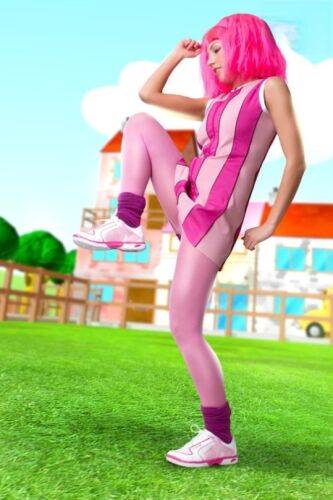 Adorable girl with pink hair Lazy Town exposes her nice body on a lawn on nudepicso.com