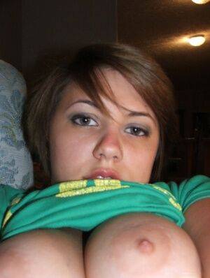 Young looking amateur takes self shots of her big natural boobs on nudepicso.com