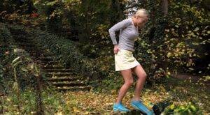 Cute blonde Victoria Pure hikes her skirt to take a pee along country lane on nudepicso.com