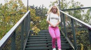 Blonde Victoria Pure pulling down her tight pants to pee on the bleachers on nudepicso.com