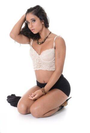 Hot Latina girl Ria Rodriguez gets naked before masturbating with a vibrator on nudepicso.com