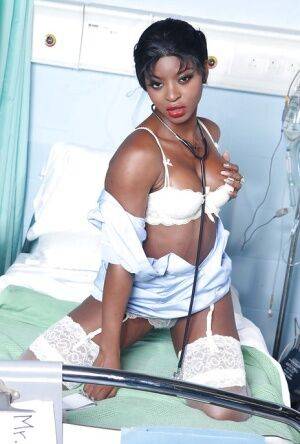 Raunchy ebony nurse with pigtails Jasmine Webb taking off her uniform on nudepicso.com