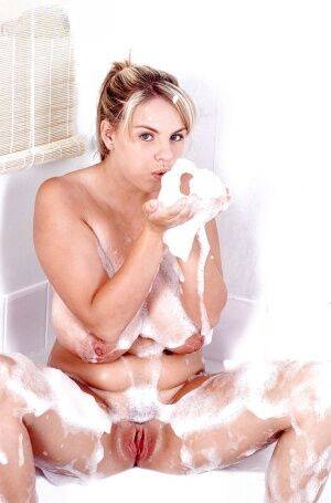 Plump Euro babe Kelly Kay soaps up huge pornstar juggs in bathtub on nudepicso.com