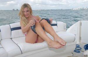 Lusty blonde Amy Brooke strips bikini and rubs pussy on the boat on nudepicso.com