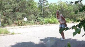 Blonde female Nikki Dream can't hold her pee any longer and squats on roadway on nudepicso.com