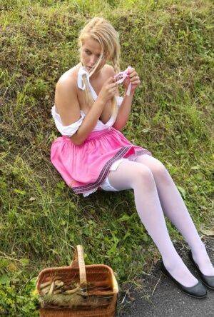 Cute blonde teen Nikki Dream hikes her skirt to masturbate in the countryside on nudepicso.com