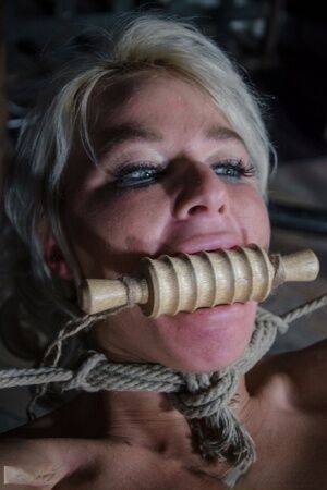 Platinum blonde London River is gagged and tied up in a dungeon on nudepicso.com
