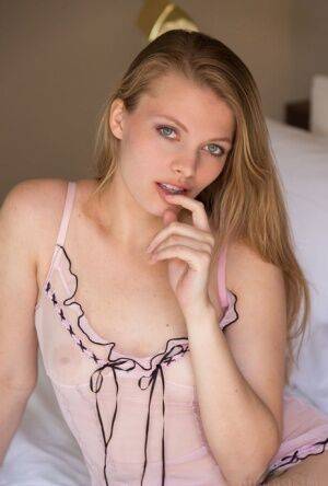 Nice teen Sophie Sparks sheds sheer lingerie to model naked on her bed on nudepicso.com