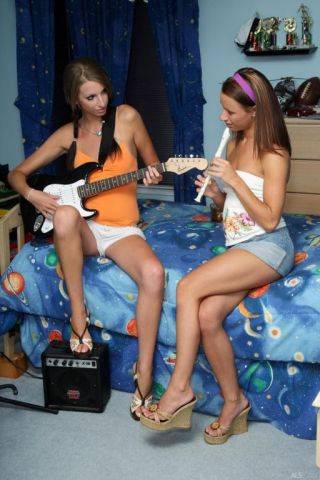 Sexy girls play some music and fuck with a huge strapon dildo on nudepicso.com