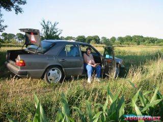 Mature plumper showing her big boobs in the car outdoors on nudepicso.com