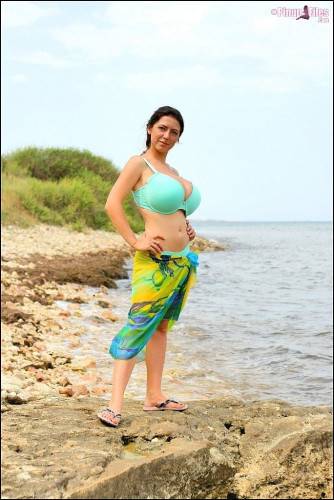 Excellent ukrainian brunette milf Merilyn Sakova revealing big titties and butt on the beach - Ukraine on nudepicso.com